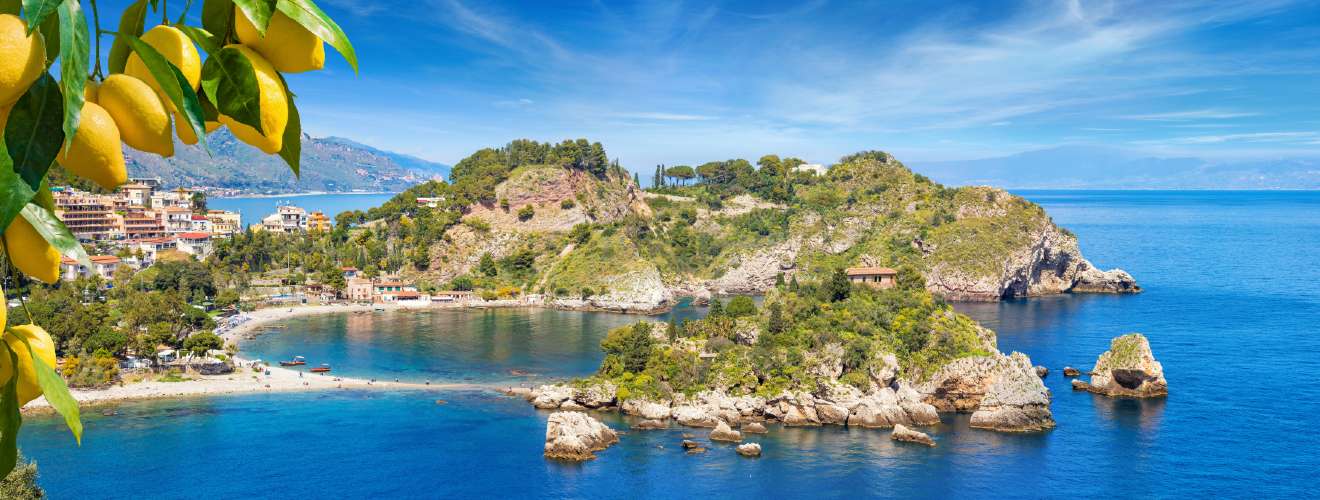 Scenic view of Isola Bella in Taormina, Sicily, surrounded by turquoise sea and vibrant coastal landscape