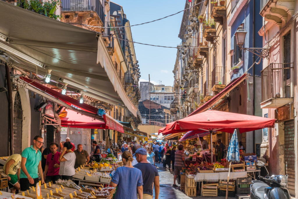 A lively Catania street market in Sicily,   during a radiant summer morning.