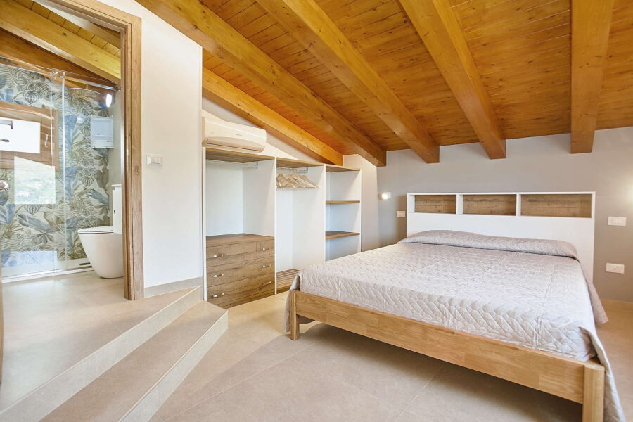 VillaPietraDorata-CastellammareDelGolfo-CharmingBedroom-ScentOfSicily Elegant Bedroom with En-Suite and Wooden Beam Ceiling at Villa Pietra Dorata – Sicily Luxury Villas