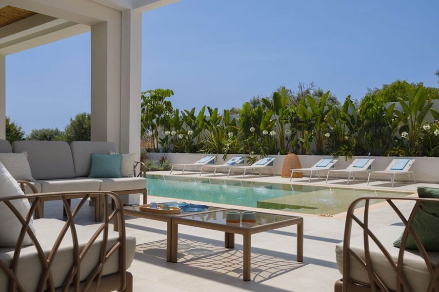 Covered outdoor lounge with sofa by the pool at Azure Essence villa in Sicily