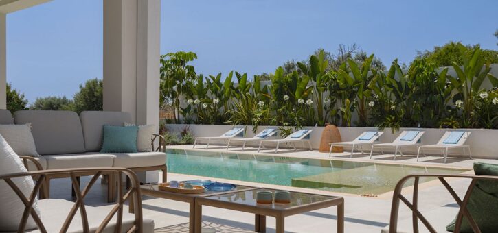 Covered outdoor lounge with sofa by the pool at Azure Essence villa in Sicily