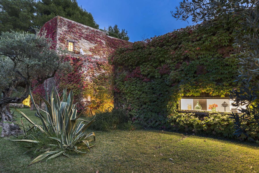 Exterior of Villa Selvira, a rustic Sicily luxury villa wrapped in ivy with soft evening lights