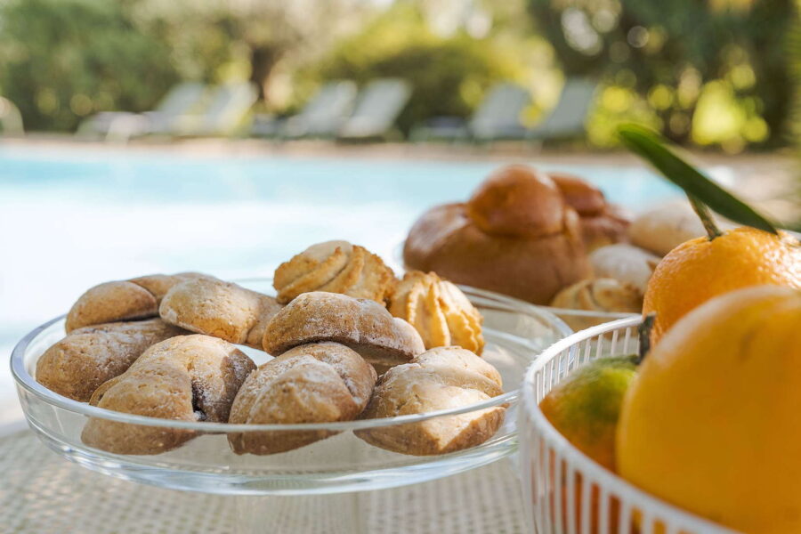 Traditional Sicilian pastries and citrus fruit served by the pool at Villa Selvira, a Sicily luxury villa.