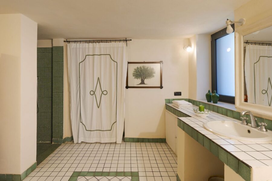 Elegant tiled bathroom with green accents at Villa Selvira, a Sicily luxury villa with pool.